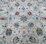 beige tone hand knotted Afghan Chobi  rug with all over floral design with a modern twist.