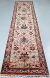 Decorative runner rug with intricate patterns on a plain background