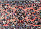 Close-up of a pink tone floral handmade Persian Sarough hallway runner rug 