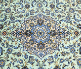 Decorative large room size Persian Kashan rug with blue and gold elements on a light green background