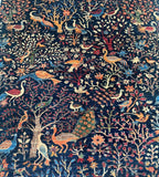 Decorative Afghan Chobi Rug with intricate patterns of birds, flowers, and trees on a dark blue background.