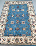 Full room size hand knotted Afghan Chobi rug with intricate patterns on a blue background at Persian rug warehouse WA in Perth