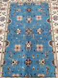 Decorative full room size handmade Afghan Chobi rug with intricate patterns on a blue background