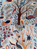 Decorative Afghan Chobi rug with birds, trees, and flowers on a blue background