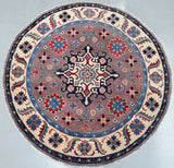 Round decorative rug with intricate patterns on a plain background