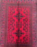 Handmade Afghan Kunduz wool rug 1.5x1m with bold crimson field and navy tribal motifs. Authentic craftsmanship, perfect accent size for entryways or smaller spaces.
