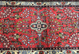 Decorative Persian Lilian hall runnerrug with intricate patterns and a prominent red background