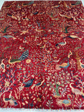 Decorative garden design Afghan Chobi Rug with intricate patterns of birds and flowers on a red background