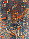 Decorative Afghan Chobi rug with peacocks, trees, and flowers on a blue background