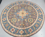 Round decorative Kazak rug with floral patterns on a plain background