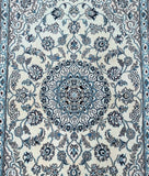 Decorative Persian Nain rug with intricate blue and white floral pattern