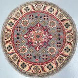 Round decorative Kazak rug with intricate patterns on a light grey background
