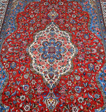 A vibrant, multicolored Persian Bakhtiari rug with a central medallion design featuring French roses, on a fine cotton base.