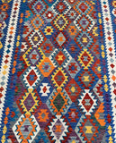 Multicolored geometric patterned boho Afghan Ariana Kilim rug with a mix of blue, orange, red, and yellow.