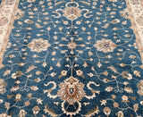 Close-up view of a hand-knotted wool Afghan Chobi rug featuring a traditional floral pattern in a blue, beige, brown, green, and grey color palette.