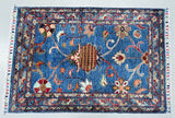 Decorative Afghan Chobi rug with intricate patterns on a plain background