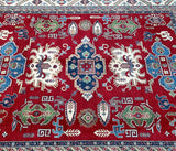 A decorative, large room-size Caucasian design hand-knotted Afghan Kazak rug with a geometric pattern, featuring a mix of red, beige, light blue, and indigo blue tones.