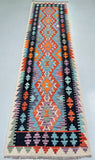 Colorful Afghan Waziri Hall Runner rug with geometric design background