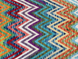 A vibrant multicolored geometric boho design Afghan kilim hall runner rug.