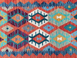 A vibrant multicolored geometric patterned Afghan kilim hall runner rug.