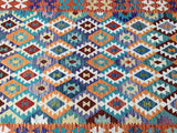 Colorful geometric patterned Afghan Kilim Rug with a mix of orange, blue, red, and white.