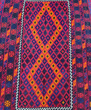 A vibrant, multicolored geometric tribal Afghan Meymaneh Kilim rug with a rich pile and a border in a contrasting color.