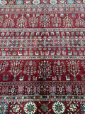 A close-up image of a handmade Afghan Super Kazak rug featuring a geometric pattern with animal motifs, predominantly in maroon, blue, green, and brown tones.