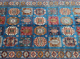 A certified handmade Afghan Ferahan Kazak rug with a blue background and multicolored geometric medallion design, woven on a cotton base.