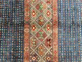 Multicolored patterned rug with geometric designs on a blue background