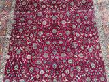 Antique Persian Tabriz rug with a floral design and multiple colors including red, beige, orange, and pink.