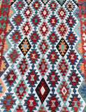 Room size Afghan kilim rug geometric design in red, blue, and orange on a white background Shoparug