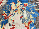 A Contemporary Afghan Chobi Rug with a vibrant abstract design in beige, blue, red, yellow, and charcoal tones, hand-knotted on a cotton base.