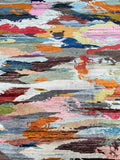 A multicolored contemporary handmade Afghan Gabbeh rug with a mix of vibrant and subdued colors.