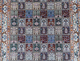 A detailed Persian Birjand rug with a garden design featuring various geometric patterns in a variety of colors.