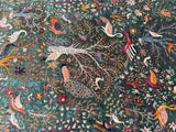 Colorful embroidered Afghan Chobi Rug with intricate patterns of birds and flowers on a dark green background
