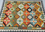 Colorful geometric patterned kilim rug with vibrant colors.