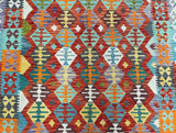 Colorful geometric Afghan Kilim rug with a diamond shape.