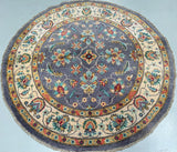 Round decorative rug with floral patterns on a light blue background
