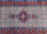 A traditional handcrafted Persian Birjand hall runner rug with a geometric Herati design in a multicolored pattern featuring beige, red, black, blue, orange, and brown tones on a fine cotton base.