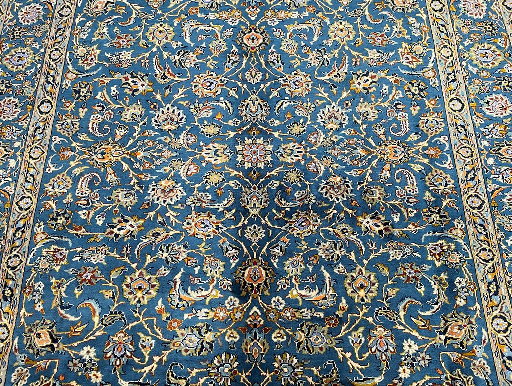 Kashbar Rug A detailed view of a Persian Kashmar rug with a floral pattern in blue ...