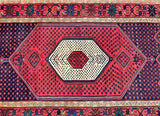 Close-up of a Persian Khamseh rug with geometric design