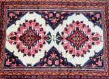 A hand-knotted Persian Lilian rug featuring a floral design with beige, blue, red, pink, and orange tones, and a traditional geometric border.