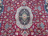 Decorative large room size Persian Mashad rug with intricate patterns and a central medallion on a red background