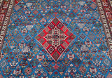A traditional Persian Meymeh area rug 420x320cm with a vibrant blue field, featuring a large red central diamond medallion and intricate geometric and floral motifs throughout.