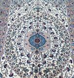 An ornate Persian Mood area rug with a cream background, featuring a central blue medallion and intricate floral motifs in blue, navy, gray, and rust red.