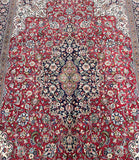 A detailed image of a traditional Persian Qum rug with an intricate floral medallion design in a room size of 3.1x2.1m.
