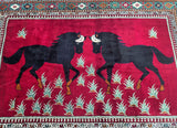A Persian Shiraz rug featuring a pictorial design with two black horse figures on a red background, woven in South Persia.