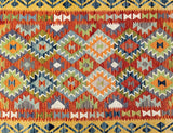 Multicolored geometric patterned Afghan Kilim rug with vibrant colors.