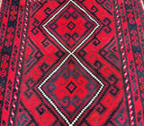 A vintage Afghan Meymaneh Kilim rug with a geometric tribal design featuring diamond medallions, in red, orange, white, black, and blue tones.