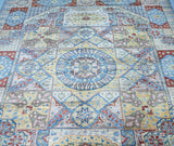 A detailed image of a multicolored, handmade Afghan Chobi rug with a geometric and floral design, featuring a central hub with a geometric pattern surrounded by a floral border.